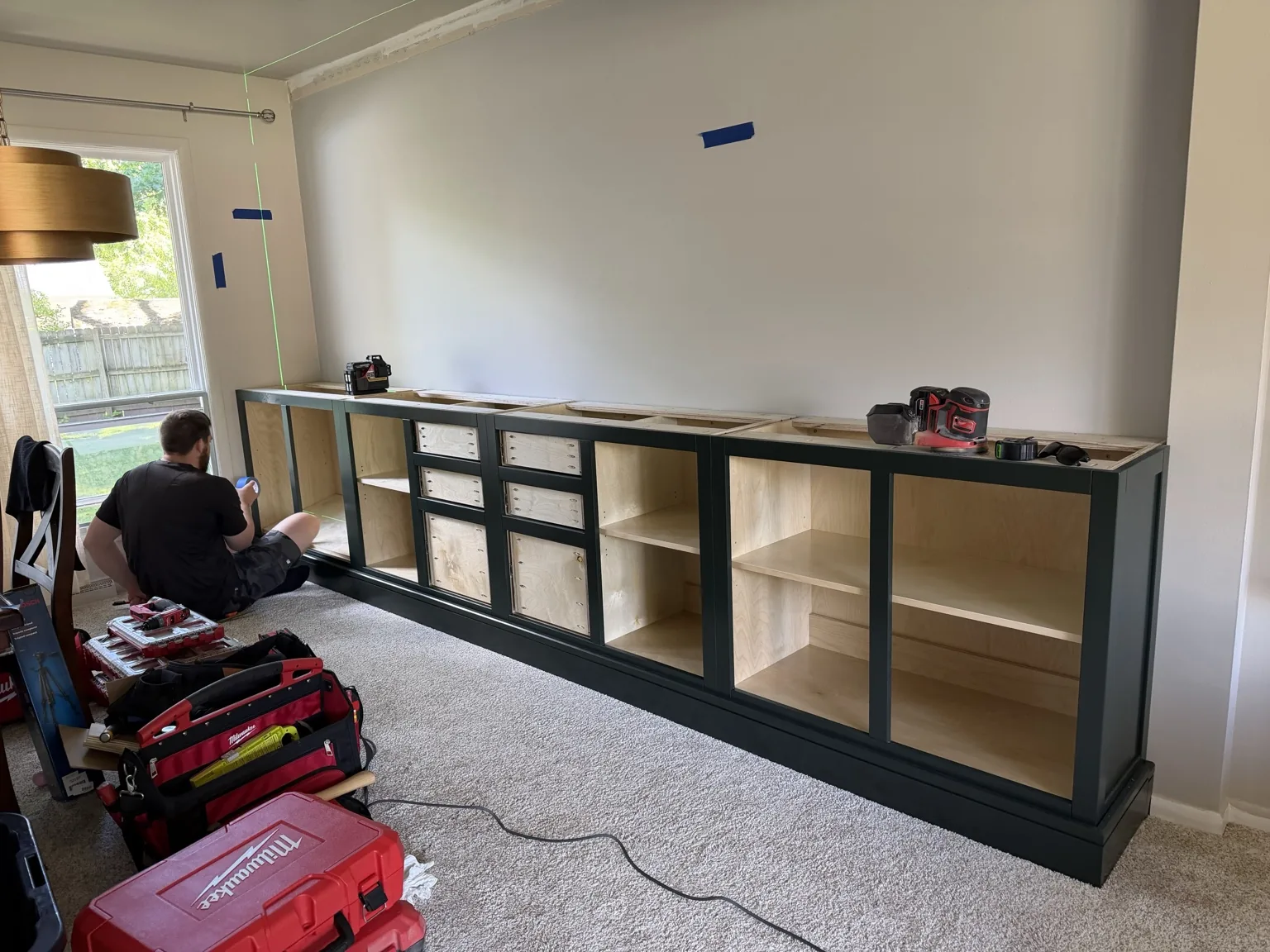 Installing and leveling the lower cabinetry on site