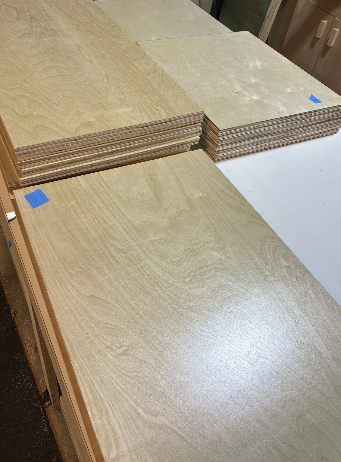 Birch plywood parts cut and stacked during fabrication