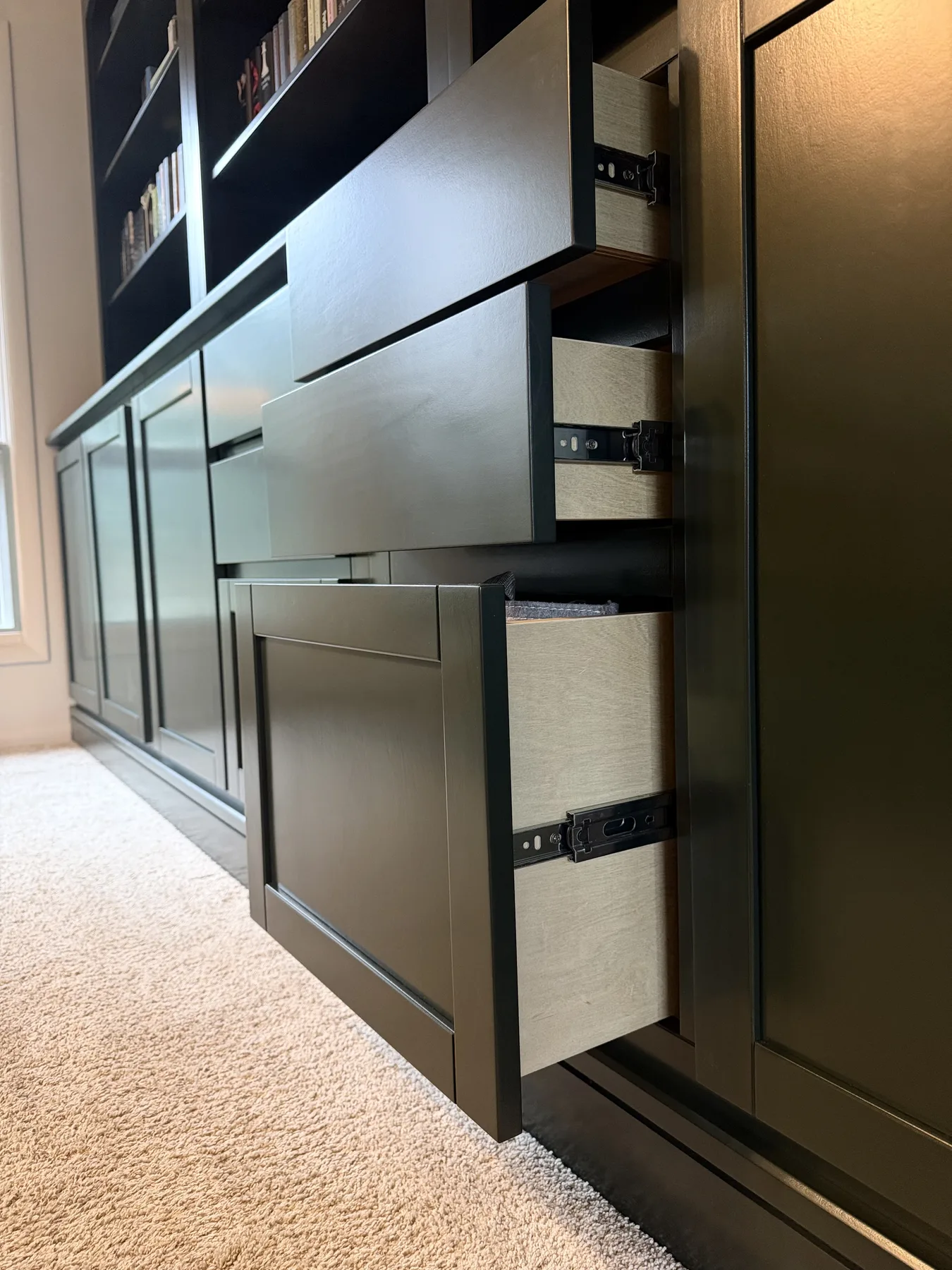 Open drawers showing both slab and shaker-style drawer fronts